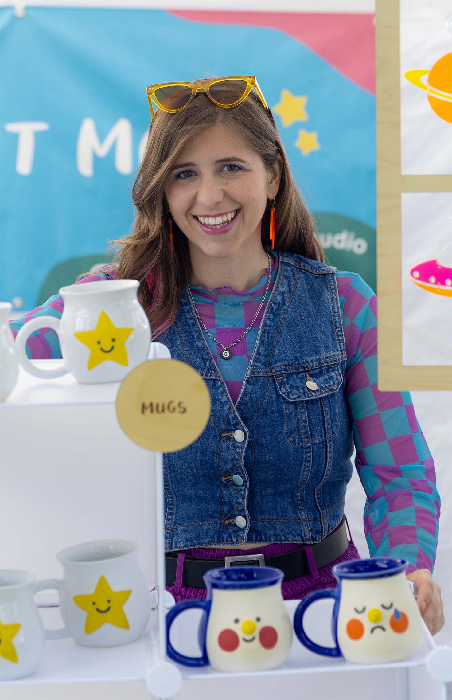 Artist Jordyn Alexander stands in her booth for her brand Verdant Moon